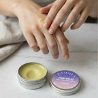 Close-up of Finishya Pink Balm being applied to the back of a hand, demonstrating the application of this vegan balm for dry and sensitive skin.
