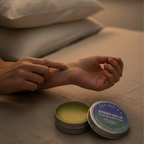 Applying Finishya Green Balm to the wrist before bed to enjoy the calming scent of Lavender and Kawakawa for relaxation.