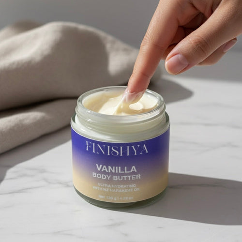 A close-up of a finger dipping into Finishya Vanilla Body Butter showing the creamy, hydrating texture.