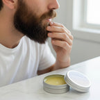 A man grooming his beard with Finishya’s Sandalwood and Amber balm for a soft, polished finish.
