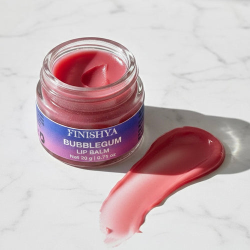 Smooth pink texture swatch of Finishya Bubblegum Lip Balm next to the jar, showing the rich, hydrating consistency.
