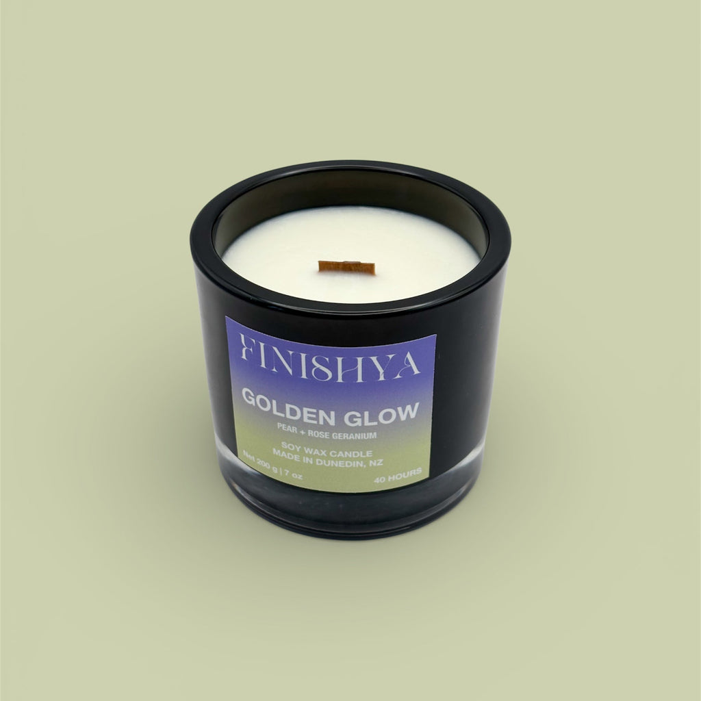 Finishya Golden Glow soy wax candle with Pear and Rose Geranium scent in a black glass jar, handcrafted in Dunedin, NZ.