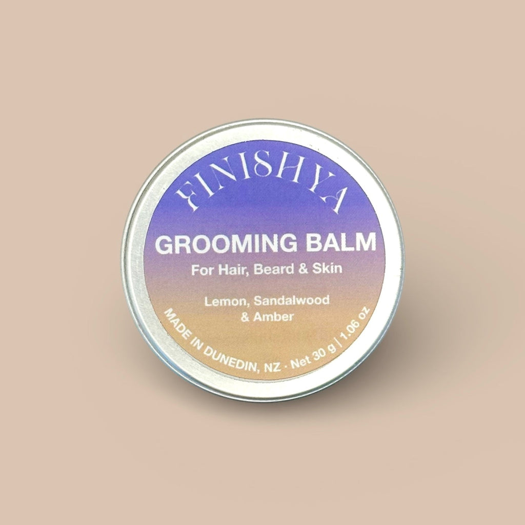 A 30g tin of Finishya Grooming Balm in Lemon, Sandalwood, and Amber scent with a gold gradient label.