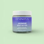 Front view of the Finishya Jasmine Body Butter 120g jar against a soft sage green background. The label identifies it as an ultra-hydrating, vegan formula with NZ Harakeke oil.