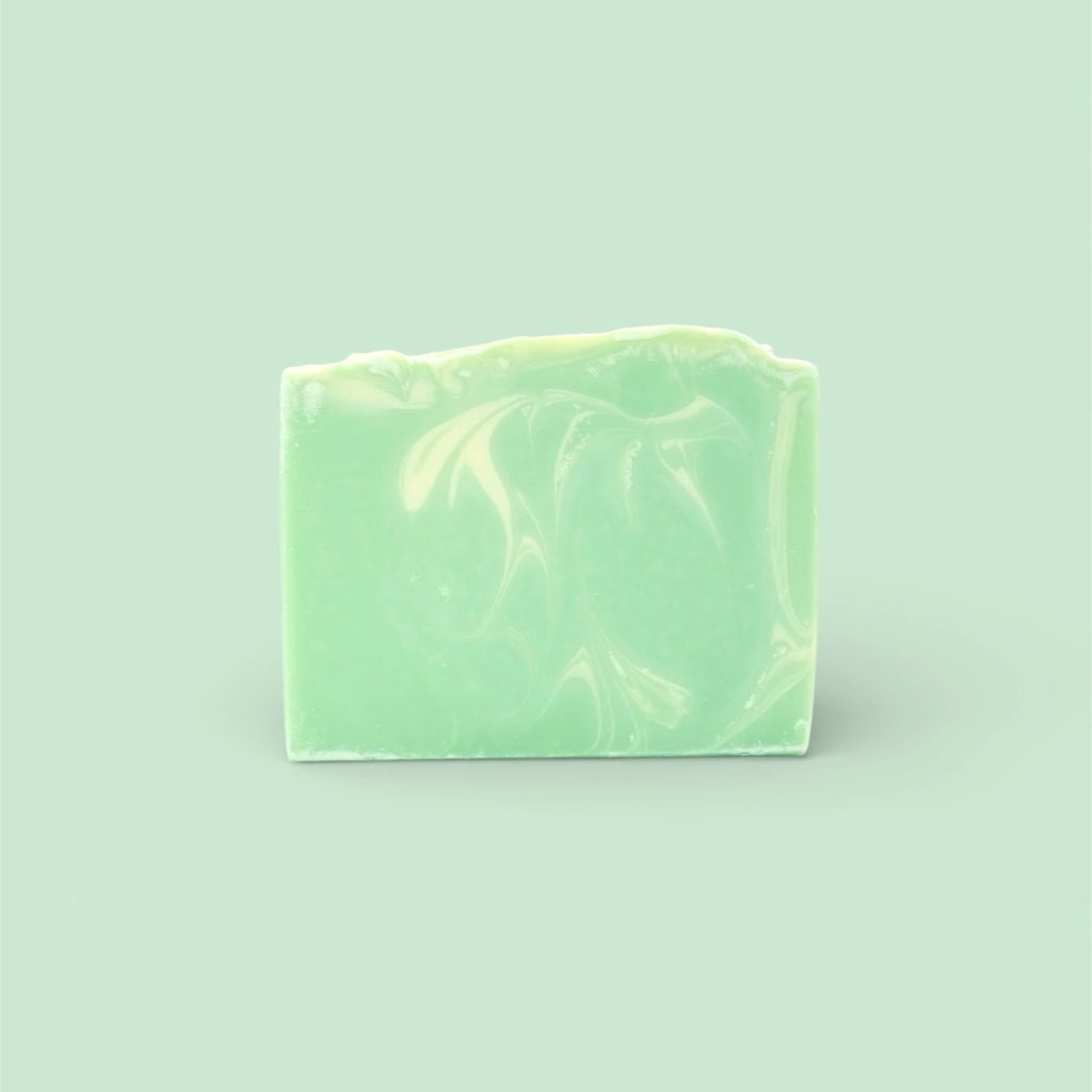 A single bar of Finishya Jasmine soap featuring a light green and white marble pattern against a soft mint background.