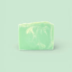 A single bar of Finishya Jasmine soap featuring a light green and white marble pattern against a soft mint background.