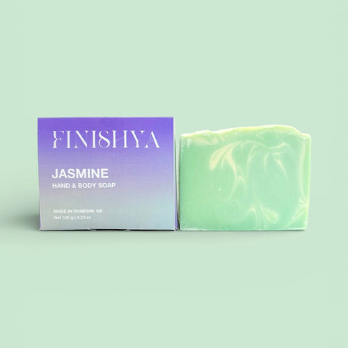 Finishya Jasmine Hand and Body soap bar next to its purple and lilac packaging, highlighting the 120g weight and Dunedin origin.