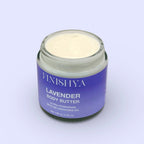 Top-down angled view of an open jar of Finishya Lavender Body Butter. The 120g glass jar shows the cream texture inside against a soft lilac background.
