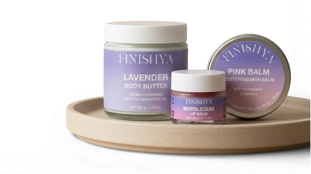 Finishya skincare collection featuring Lavender Body Butter with NZ Harakeke oil, Pink Balm restoring skin balm with Kawakawa, and Bubblegum Lip Balm. Vegan and cruelty-free skincare for sensitive skin, handmade in Dunedin, New Zealand.