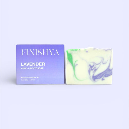 Finishya Lavender Hand and Body Soap bar next to its purple box packaging, featuring "Made in Dunedin, NZ" and "Vegan & Cruelty Free" messaging.