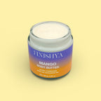Top-down view of an open jar of Finishya Mango Body Butter featuring NZ Harakeke Oil, 120g glass jar on a yellow background.