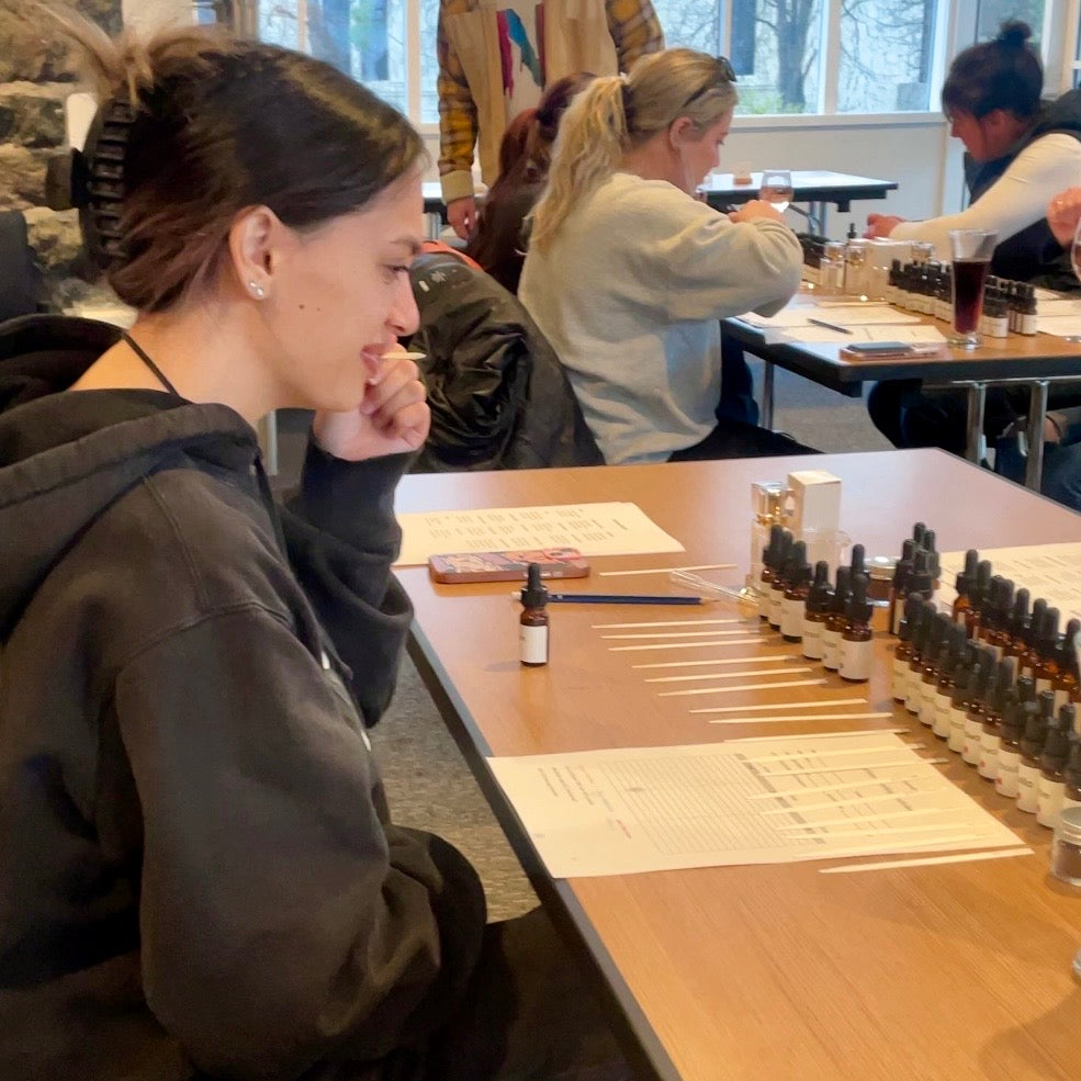 A workshop participant smelling a scent tester strip at a Finishya fragrance blending event at Guild Dunedin.