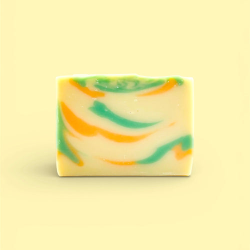 A single bar of Finishya Mango hand and body soap with yellow, green and orange swirls against a soft yellow background.