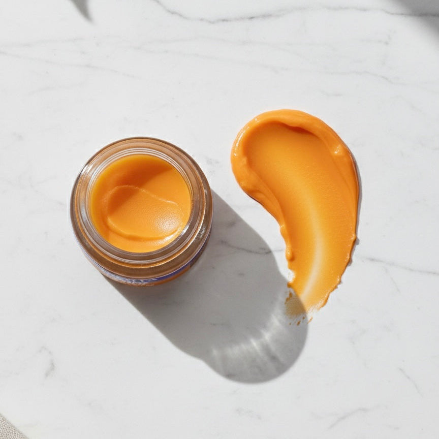 Smooth orange texture swatch of Finishya Lip Balm on a white marble surface. Cruelty-free and suitable for sensitive skin.