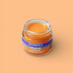 Close-up of an open jar of Finishya Orange Lip Balm showing a rich, buttery texture. Nourishing vegan lip treatment.
