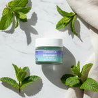 Finishya Spearmint Lip Balm jar styled with fresh mint leaves on marble, emphasising the refreshing fragrance and botanical ingredients.